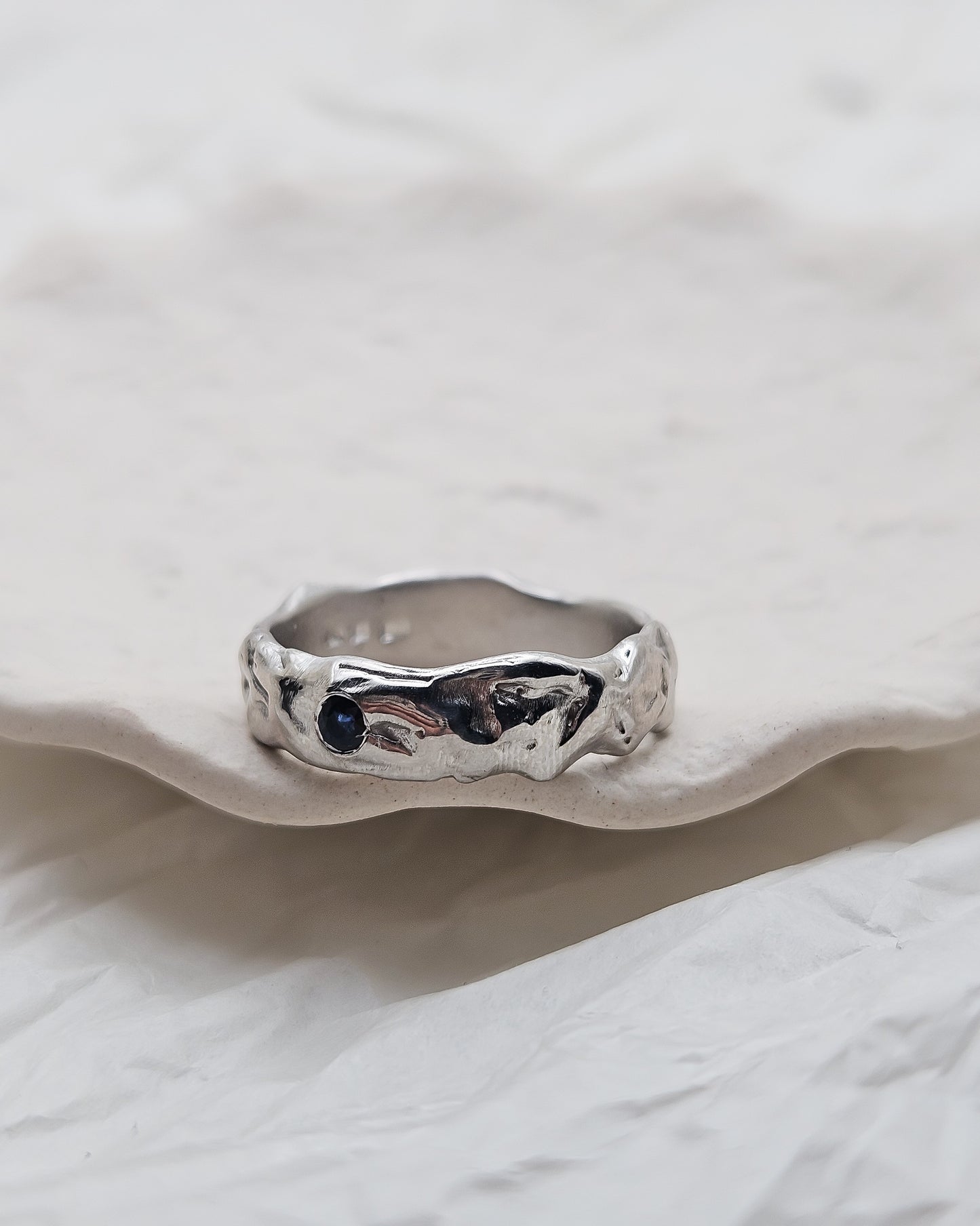 Melted ring with dark blue sapphire