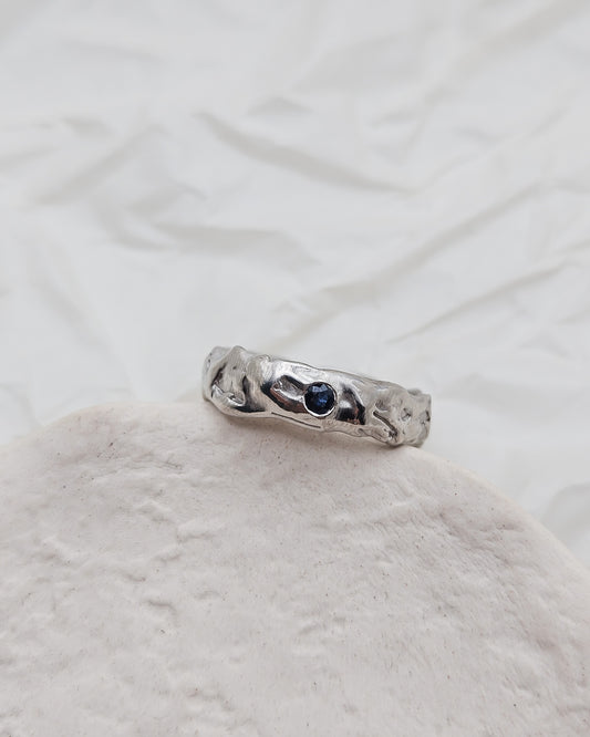 Melted ring with dark blue sapphire