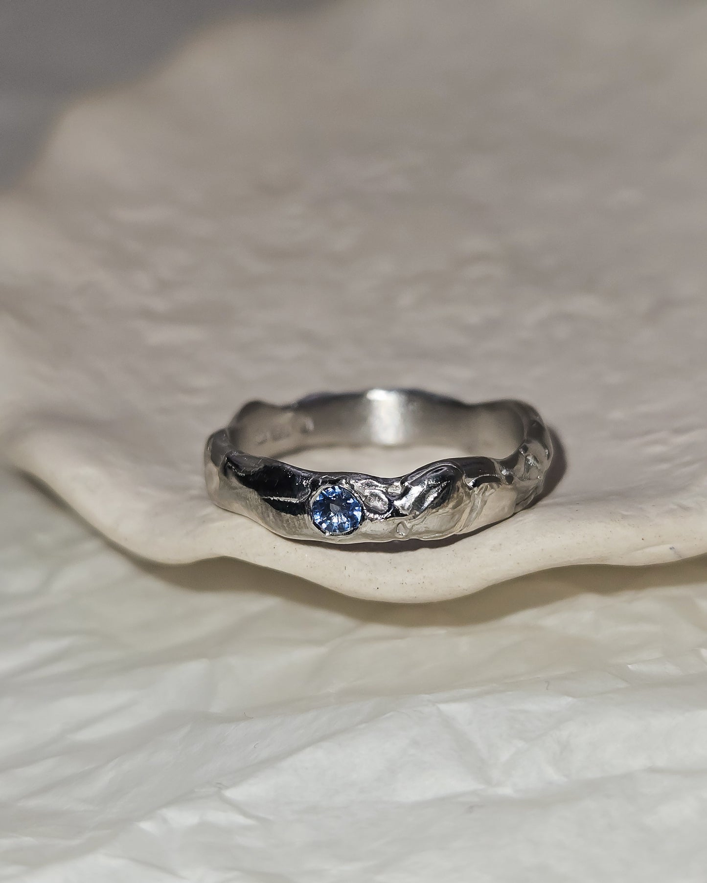 Melted ring with light blue sapphire