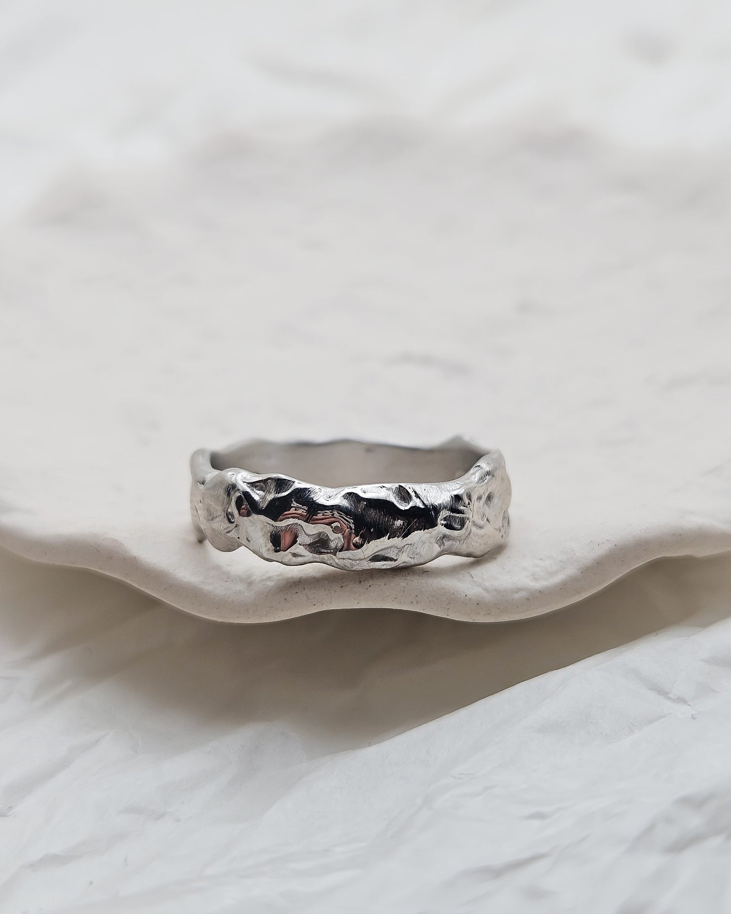 Melted ring with dark blue sapphire