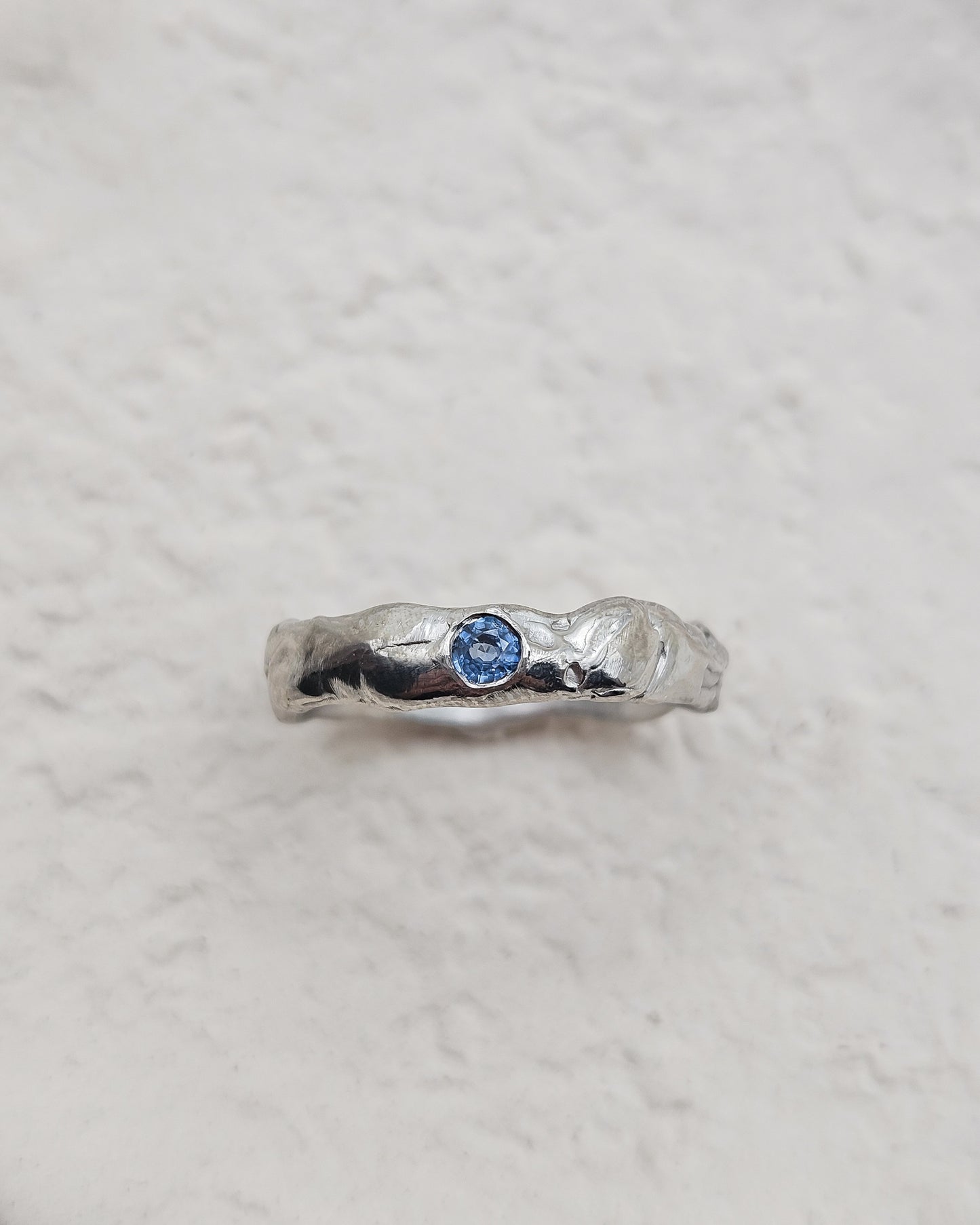 Melted ring with light blue sapphire