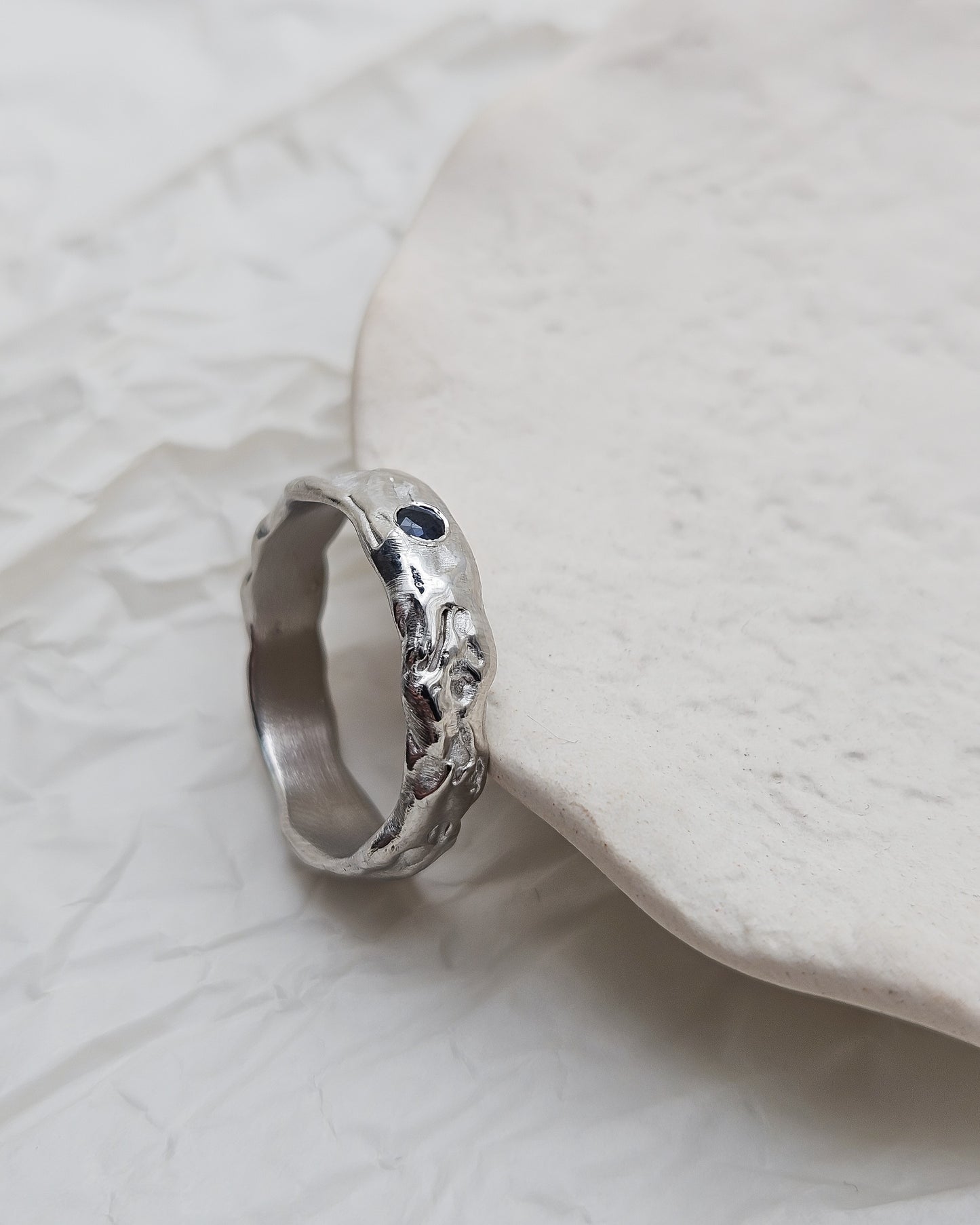 Melted ring with dark blue sapphire