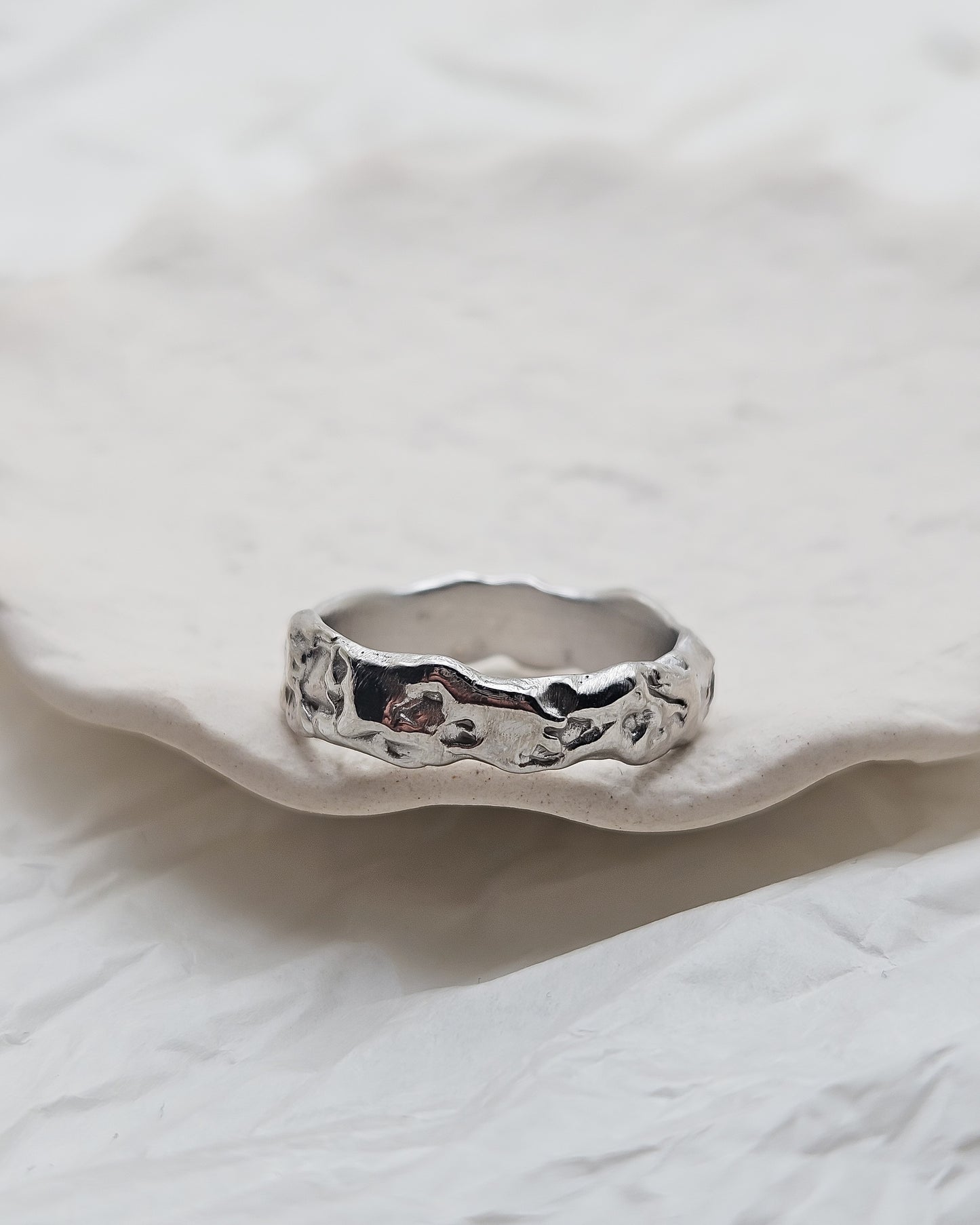 Melted ring with dark blue sapphire