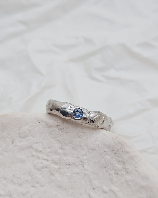 Melted ring with light blue sapphire